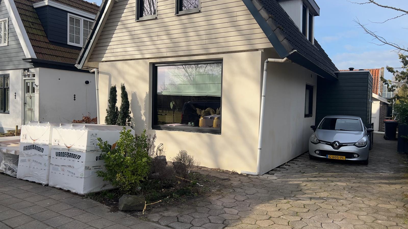 Woonhuis met oude stucgevel en pallets steenstrips vóór de renovatie, Andijk (vóór-foto)